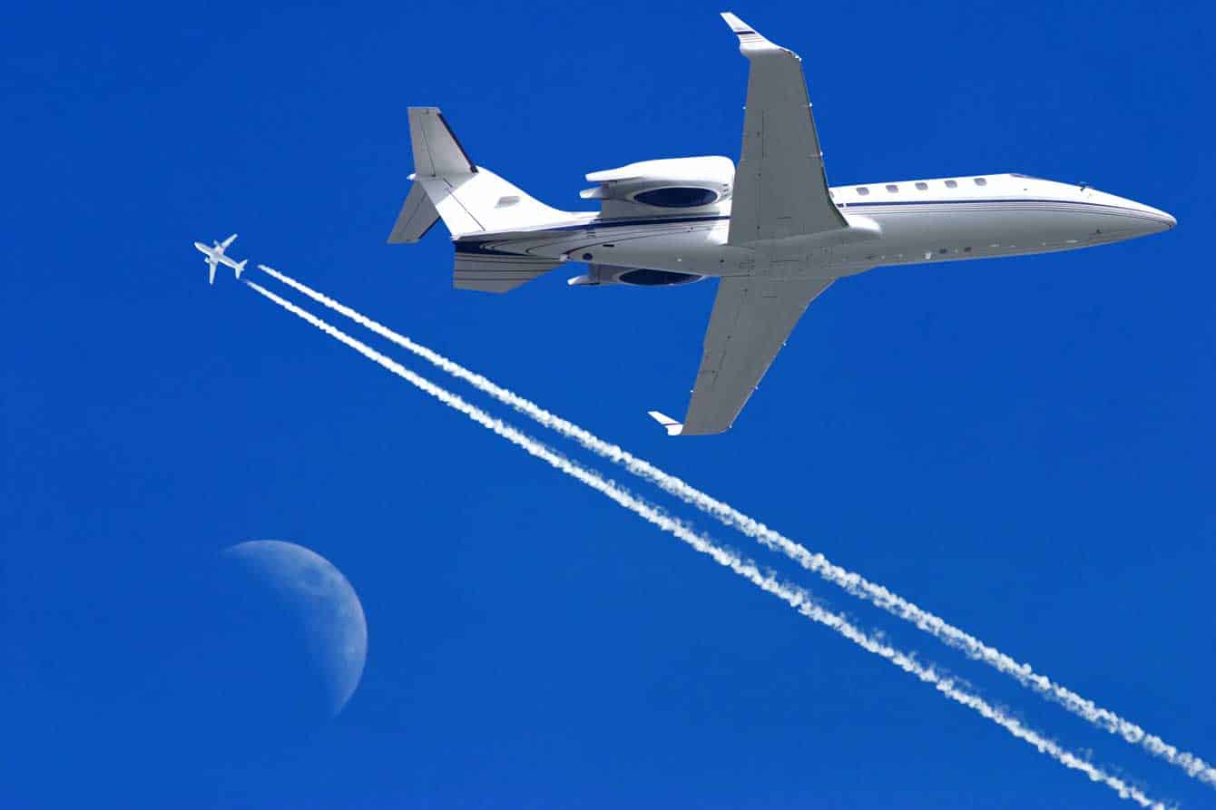 a private jet flying leaving concentration trails