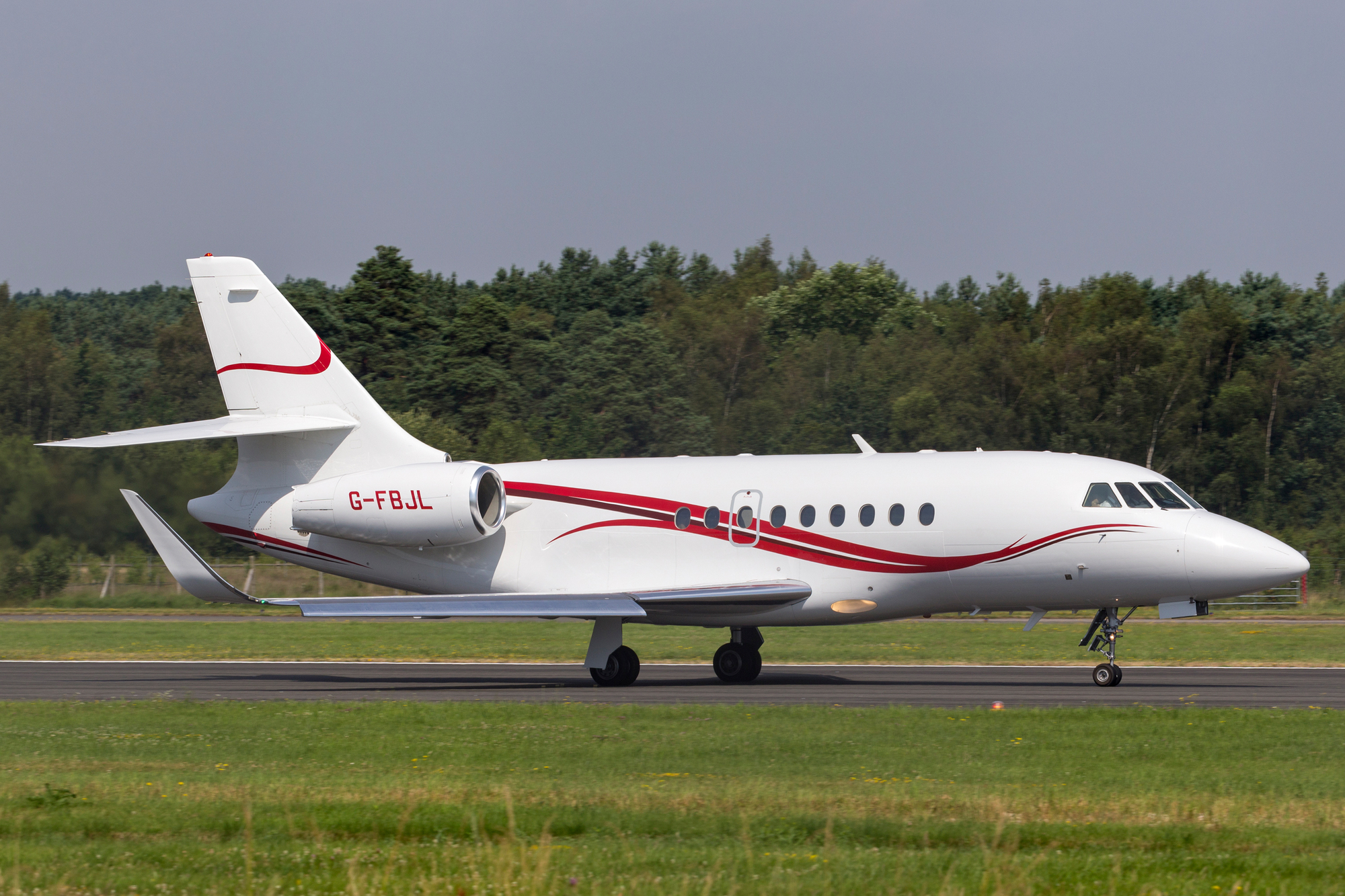 A Falcon 2000 private jet riding on the runway