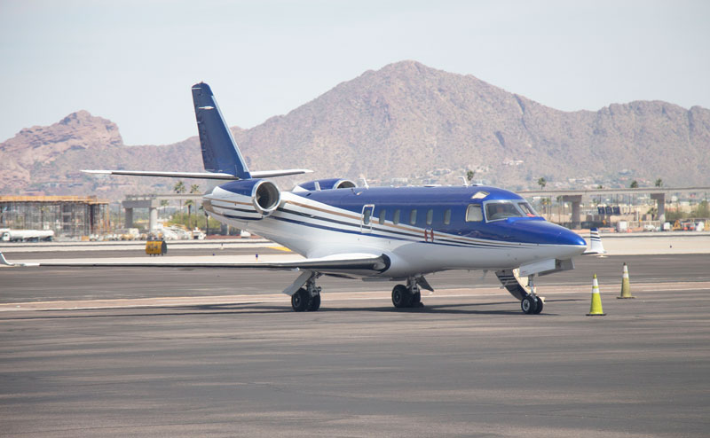 A gulfstream G100 private jet waiting on the runway