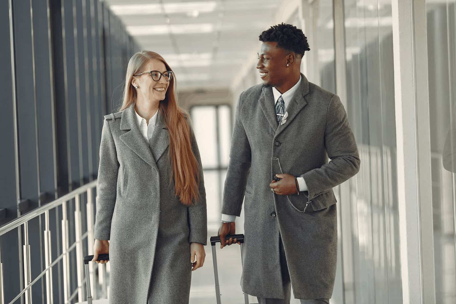 Two friends walking in an airport