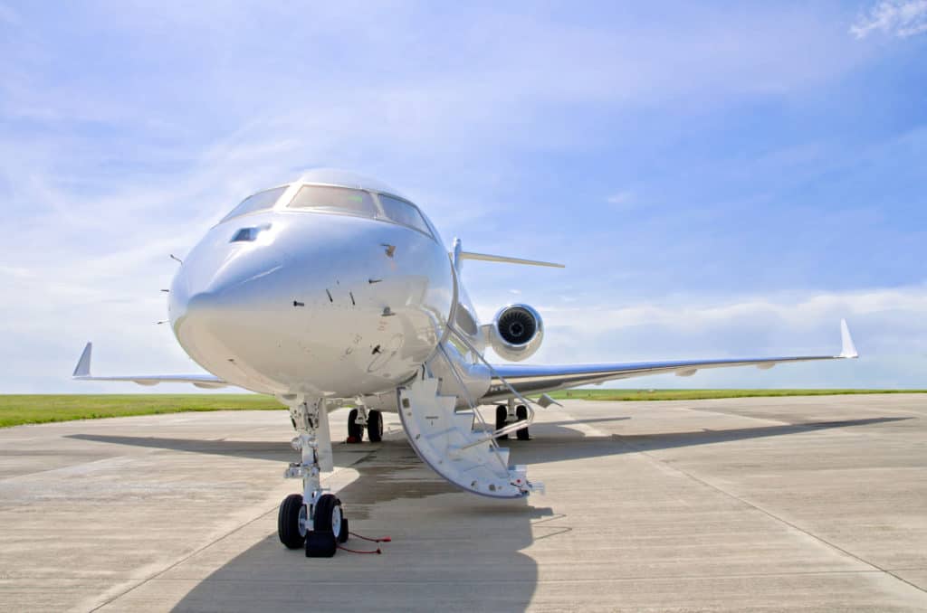 a private jet on the landing strip with open door