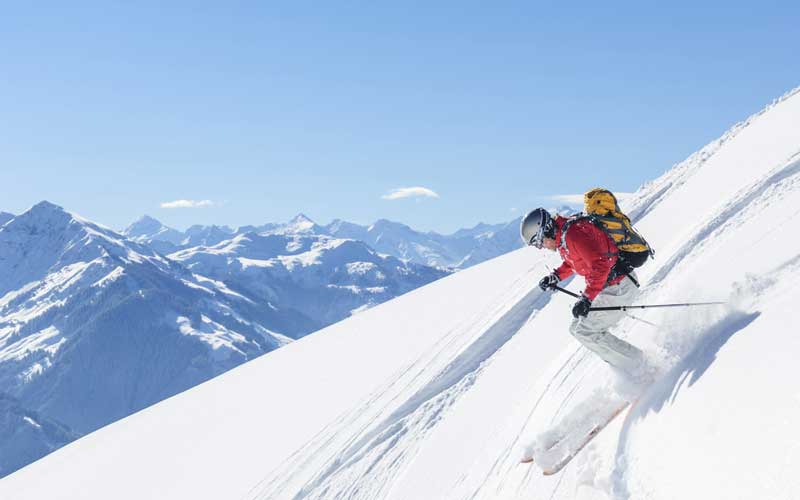 A man is skiing on the slopes of Kitzbühel