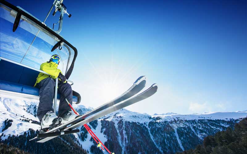 A man sitting in the ski lift going up at Lechzurs Austria