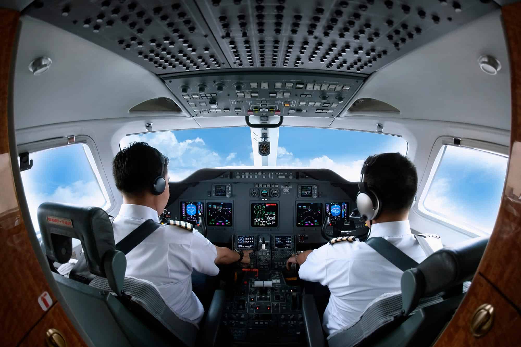 Pilots sitting in the cockpit while flying the plane