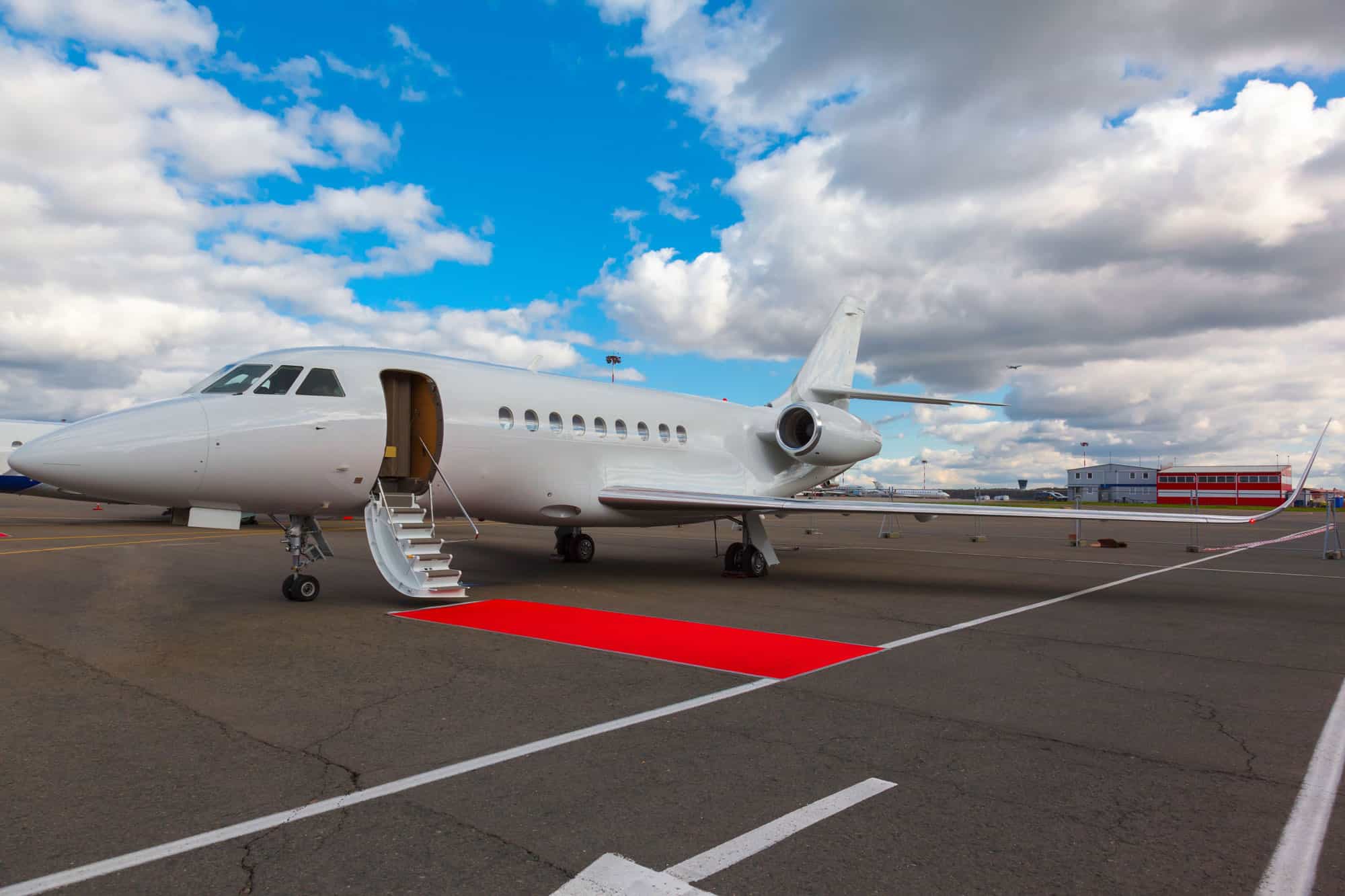 a red carpet at the entrance of a private jet