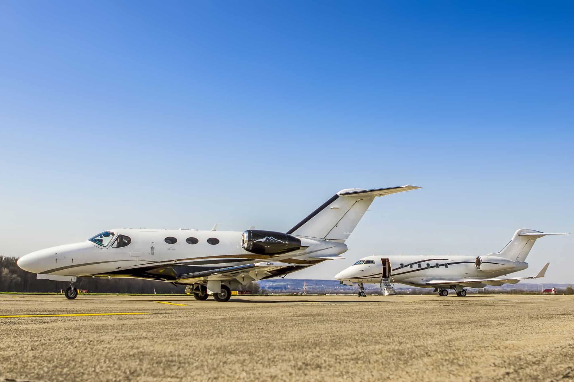 private jets stalled on a grass field