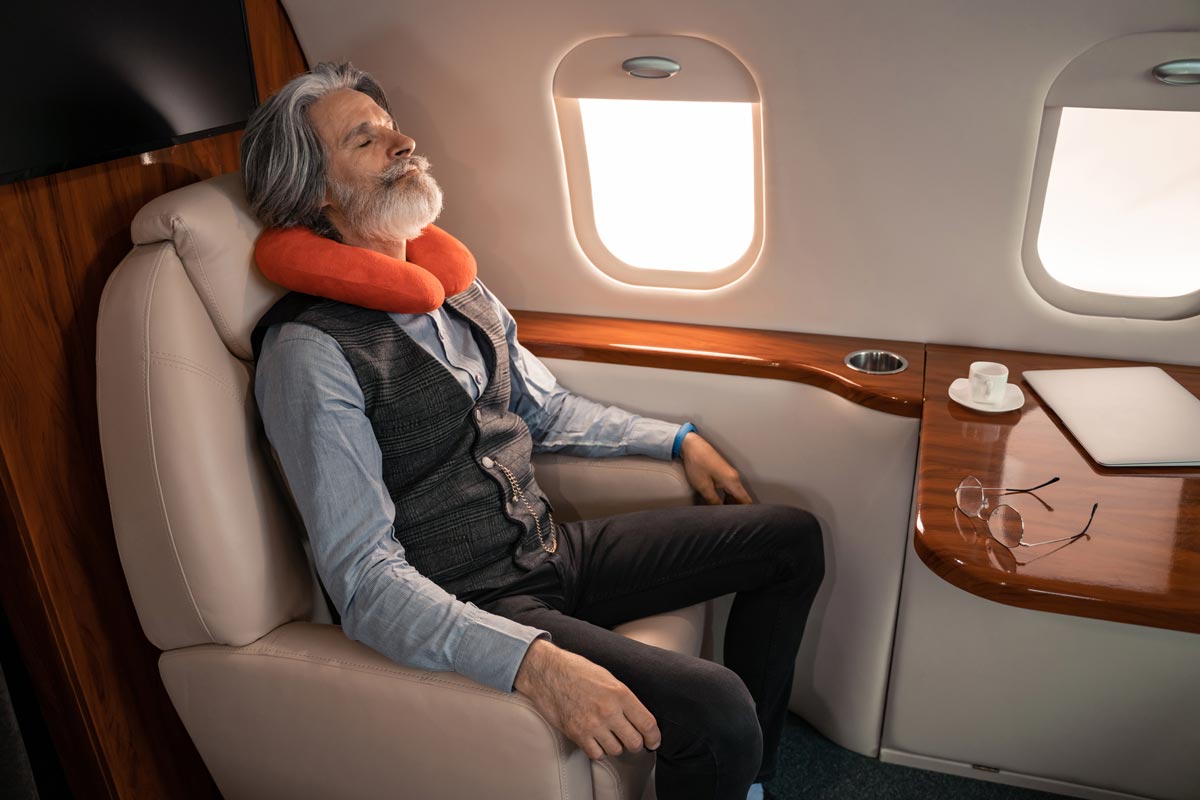 an elderly businessman comfortably resting in a private jet