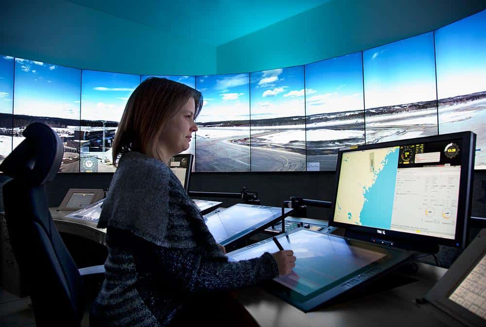 a woman working in a remote tower center