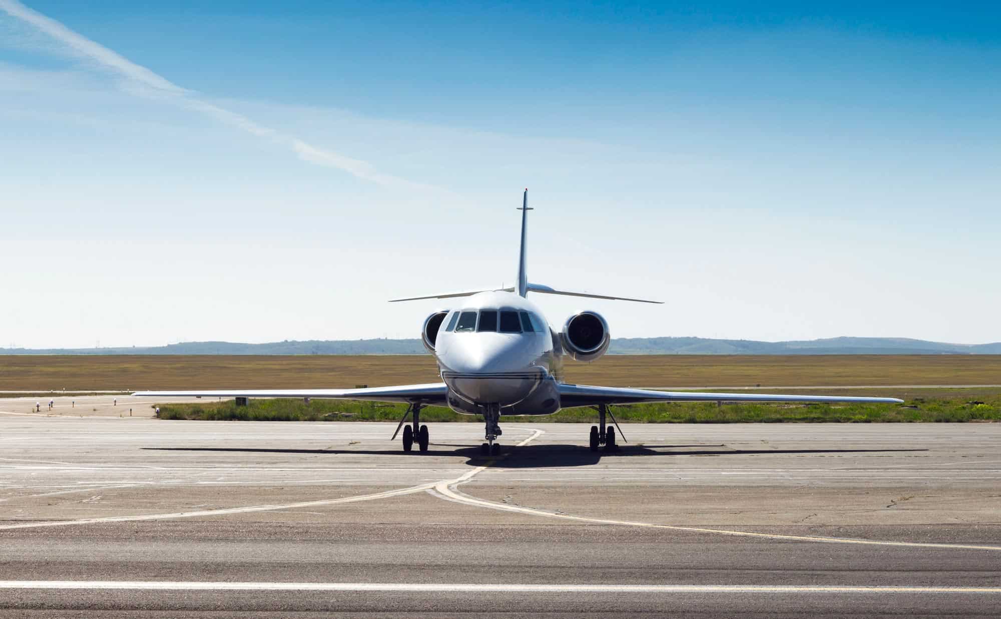 a private jet stalled on a landing strip