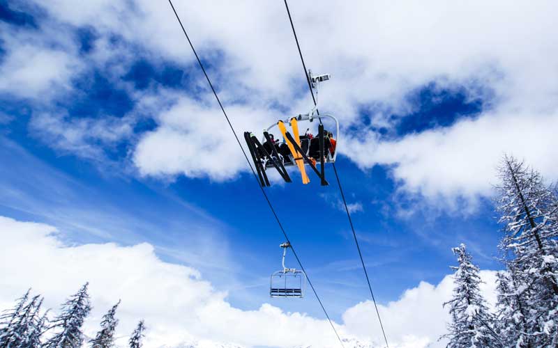 Two people sitting in a ski lift in Vail Colorado