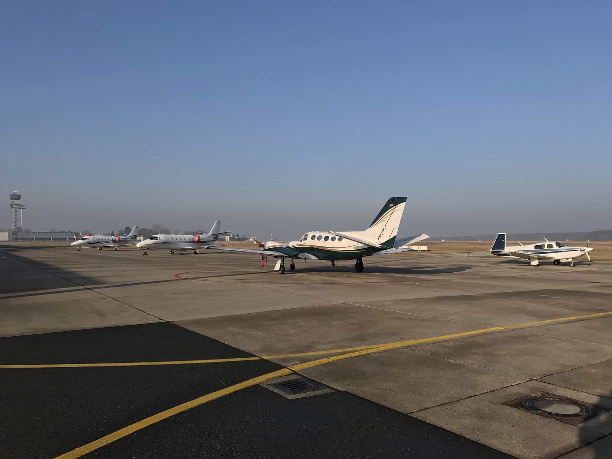 Various Private Jets parked in an airport