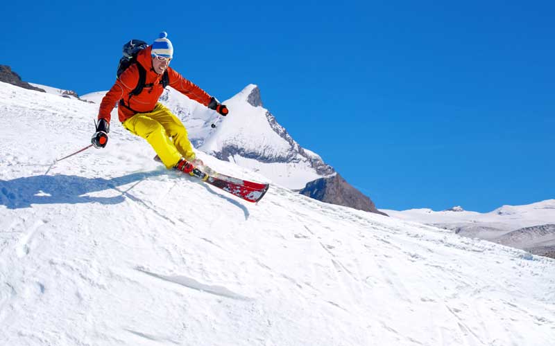 A man is skiing down the mountains of Zermatt Switzerland